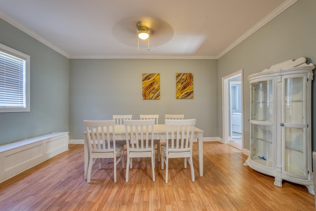 dining room with ceiling fan, crown molding, and light hardwood / wood-style flooring