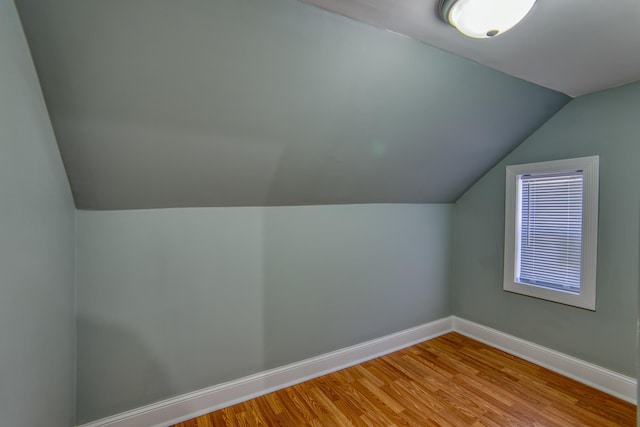 bonus room featuring light hardwood / wood-style floors and vaulted ceiling