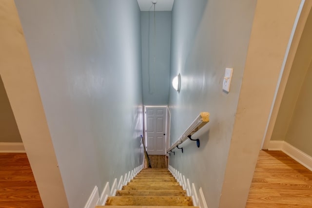 stairs with hardwood / wood-style floors