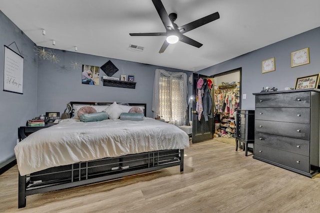  - bedroom with wood finished floors, a ceiling fan, and a closet