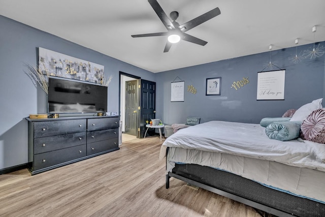  - bedroom with wood finished floors and a ceiling fan