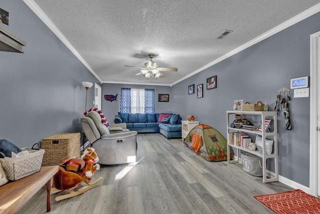  - living area with crown molding, wood finished floors, a textured ceiling, and ceiling fan
