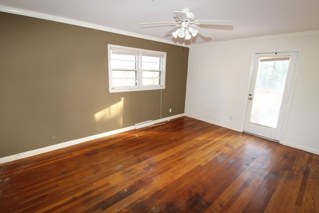 empty room featuring ornamental molding, dark hardwood / wood-style floors, and ceiling fan