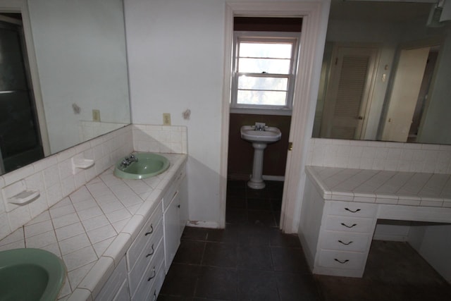 bathroom featuring sink, backsplash, and tile patterned floors