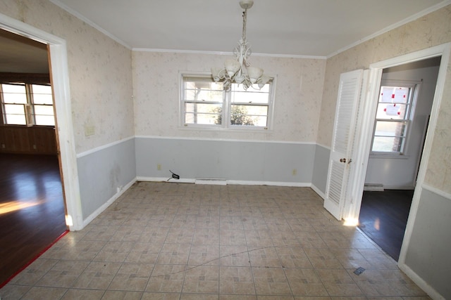 unfurnished dining area with crown molding, an inviting chandelier, and a baseboard heating unit