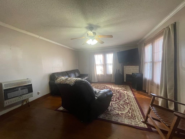 living room featuring ornamental molding, dark hardwood / wood-style floors, heating unit, and ceiling fan