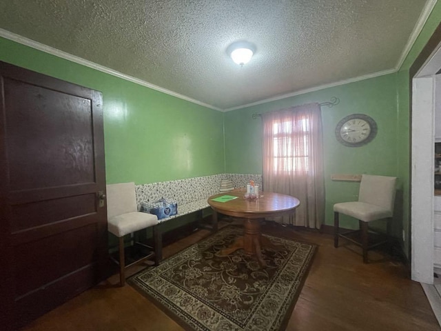 living area with crown molding, a textured ceiling, and hardwood / wood-style flooring