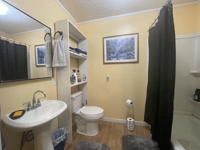 bathroom featuring walk in shower, toilet, crown molding, a textured ceiling, and hardwood / wood-style flooring