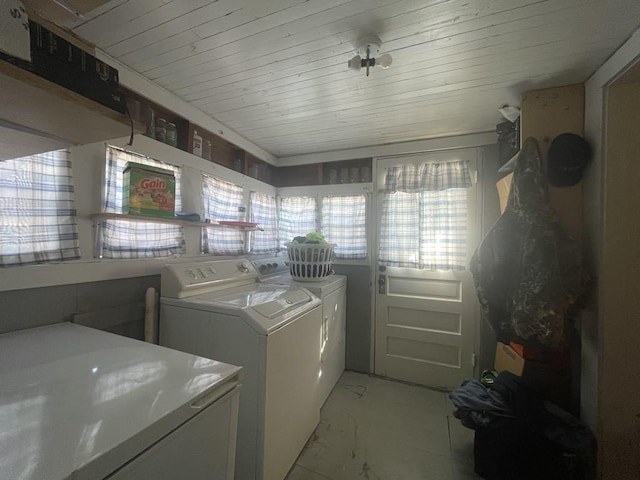 clothes washing area featuring separate washer and dryer and wood ceiling