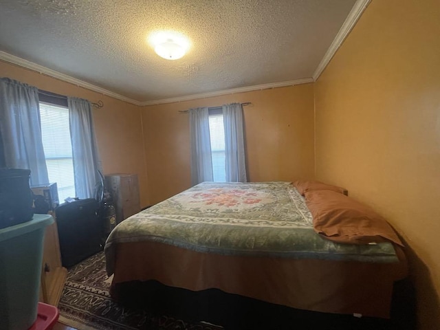 bedroom with multiple windows, crown molding, and a textured ceiling