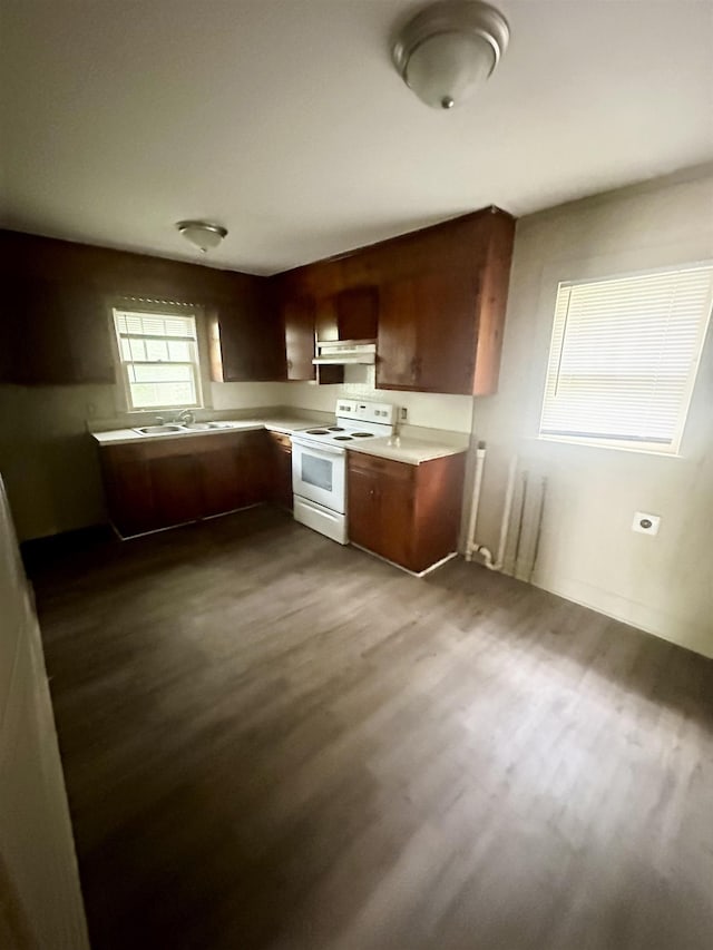 kitchen with ventilation hood, white range with electric stovetop, dark wood-type flooring, and sink