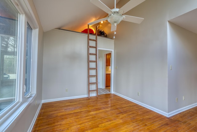 spare room with a wealth of natural light, ceiling fan, and light hardwood / wood-style flooring