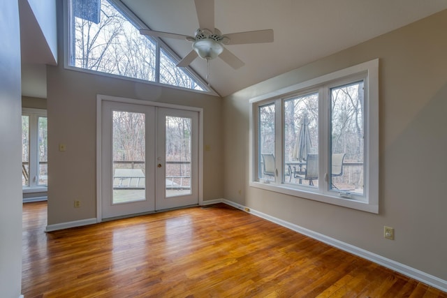 interior space featuring hardwood / wood-style floors, high vaulted ceiling, french doors, and ceiling fan