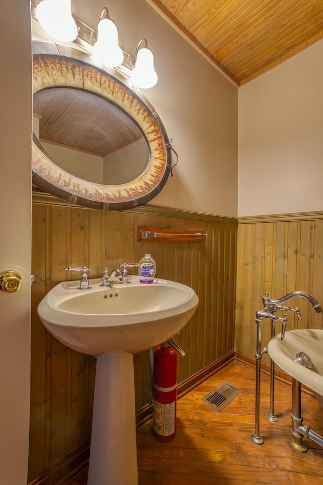 bathroom featuring hardwood / wood-style floors, wood ceiling, and wood walls