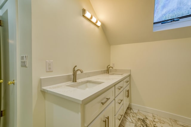 bathroom with vanity and vaulted ceiling