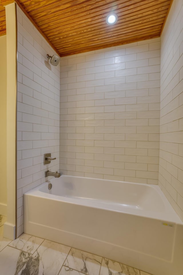 bathroom featuring wood ceiling and tiled shower / bath