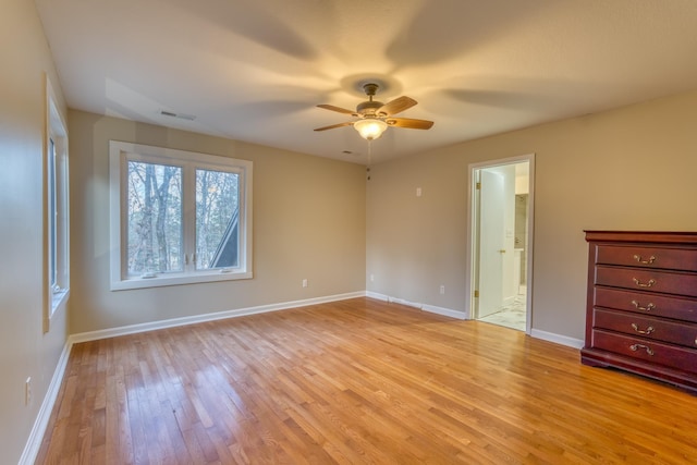 unfurnished bedroom with ceiling fan, connected bathroom, and light wood-type flooring