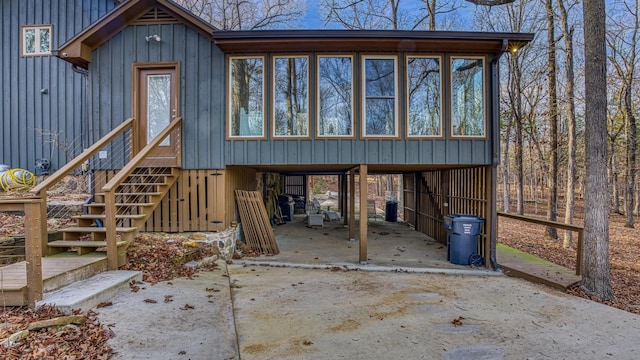 view of front facade with a carport and a sunroom