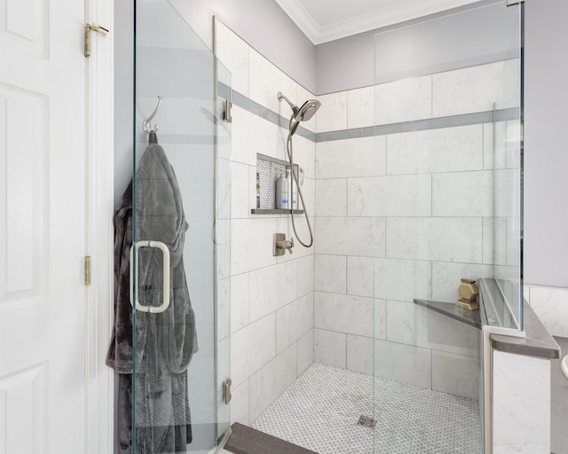 - bathroom with a shower with shower door and ornamental molding