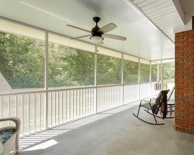  - unfurnished sunroom with ceiling fan