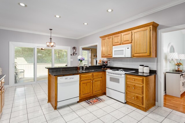  - kitchen featuring kitchen peninsula, white appliances, crown molding, light tile patterned floors, and a chandelier