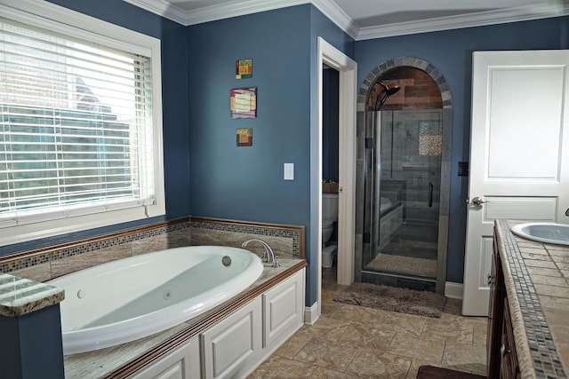 full bathroom featuring vanity, a stall shower, ornamental molding, a jetted tub, and toilet