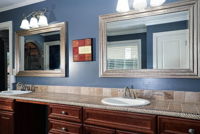 full bath with a sink, double vanity, and crown molding