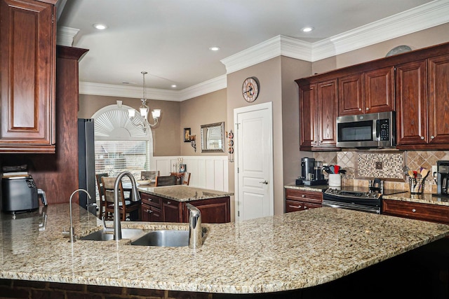 kitchen featuring a sink, a peninsula, light stone countertops, and stainless steel appliances