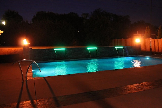 pool at twilight featuring a fenced in pool and fence