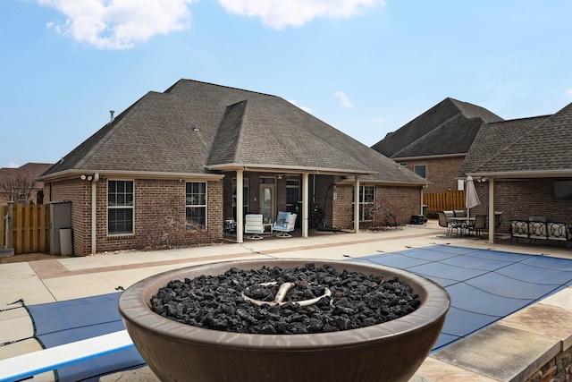 view of pool with a patio area, a fire pit, and fence