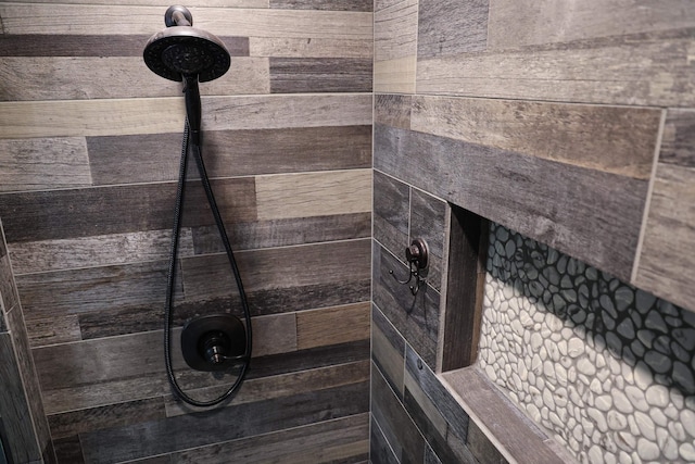 interior details featuring a tile shower