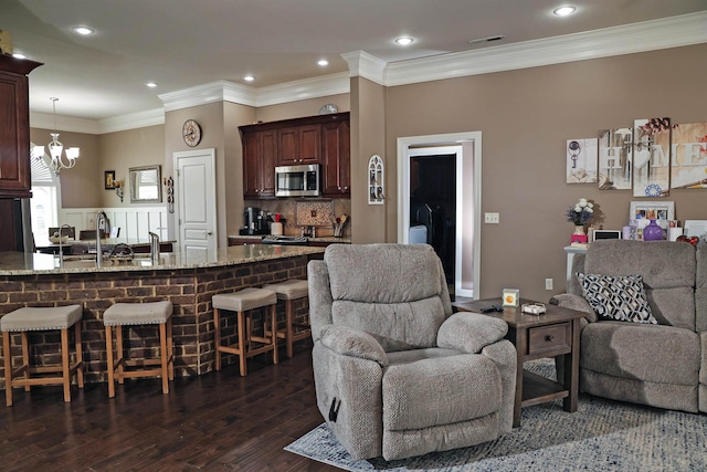 living area featuring recessed lighting, visible vents, dark wood-style floors, and ornamental molding