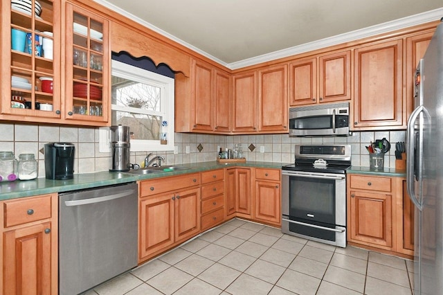 kitchen featuring decorative backsplash, ornamental molding, sink, and appliances with stainless steel finishes