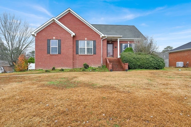 view of front of property with central AC and a front yard