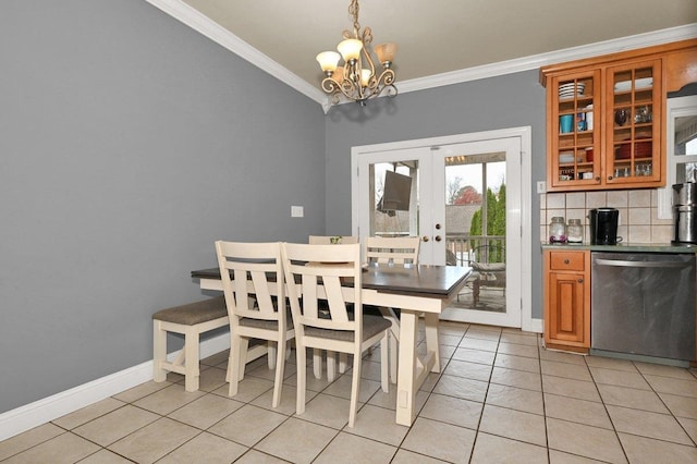 dining room featuring french doors, light tile patterned floors, crown molding, and a notable chandelier