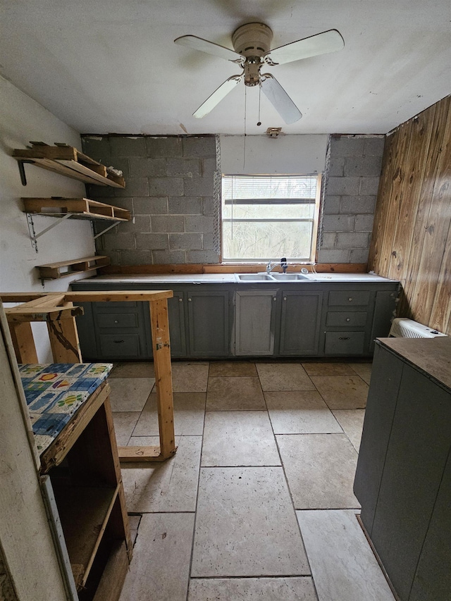 kitchen with gray cabinetry, sink, and ceiling fan