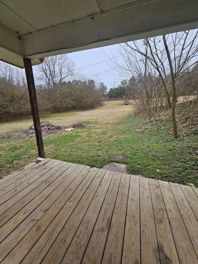 wooden terrace with a lawn