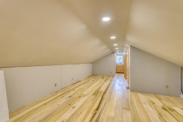 bonus room featuring hardwood / wood-style floors and vaulted ceiling