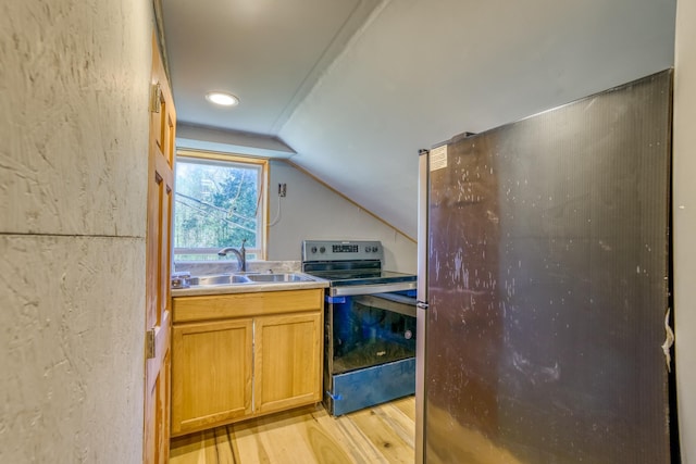 kitchen featuring light hardwood / wood-style flooring, vaulted ceiling, black / electric stove, and sink