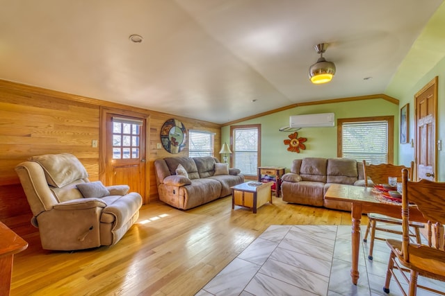 living room with a wall mounted air conditioner, plenty of natural light, light hardwood / wood-style floors, lofted ceiling, and wooden walls