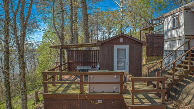 wooden deck featuring a storage unit