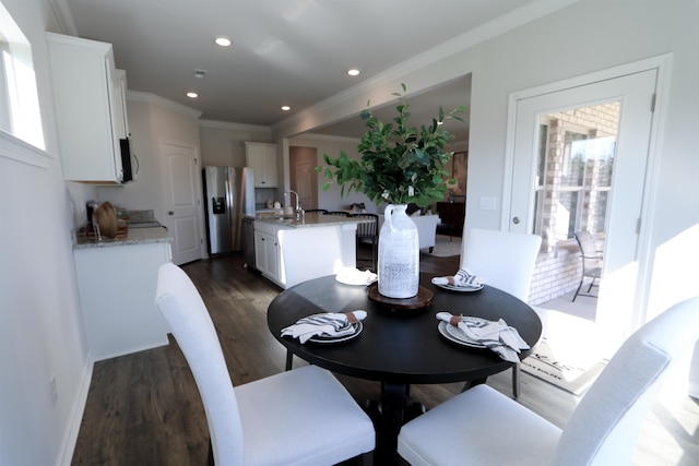 dining room featuring a healthy amount of sunlight, dark wood-style floors, crown molding, and recessed lighting