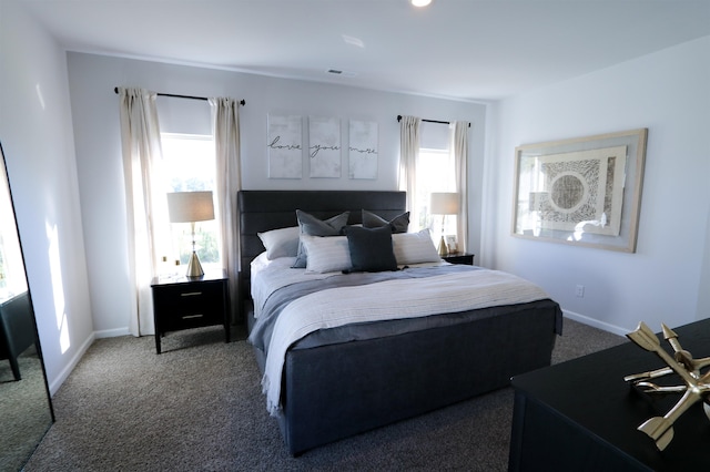 carpeted bedroom with visible vents and baseboards