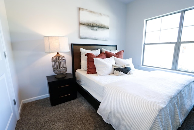 bedroom featuring baseboards and dark colored carpet