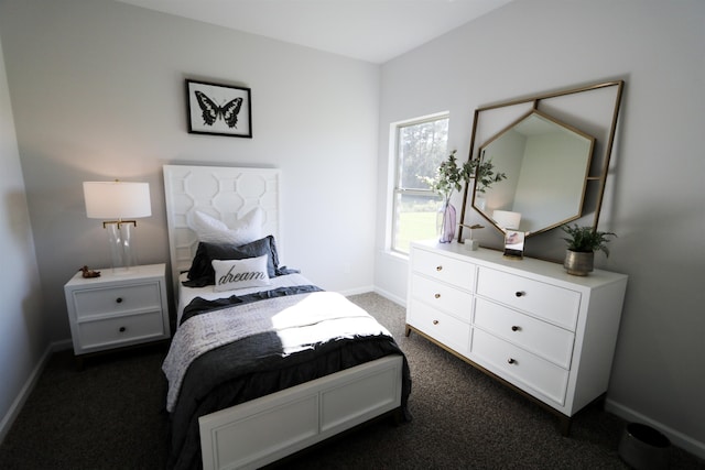 bedroom featuring baseboards and dark colored carpet