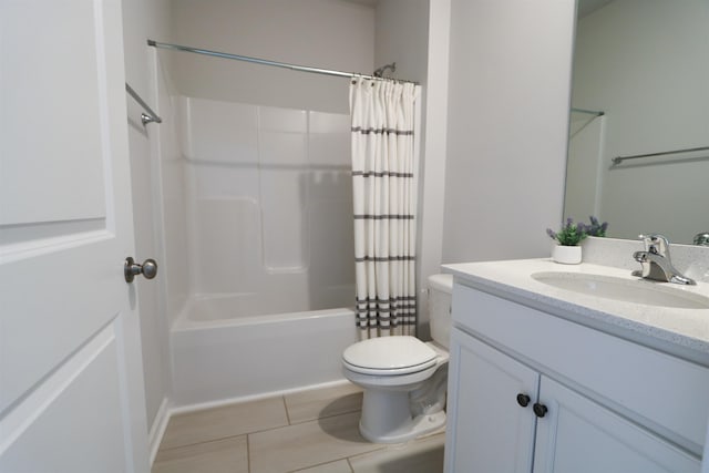 bathroom featuring toilet, tile patterned flooring, shower / bath combo with shower curtain, and vanity