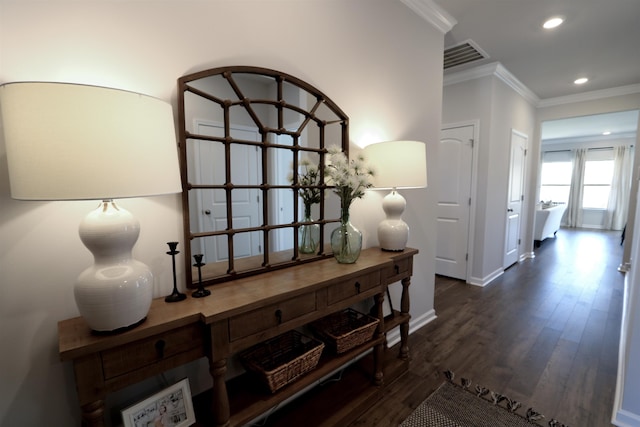 hallway with visible vents, baseboards, dark wood-style floors, ornamental molding, and recessed lighting