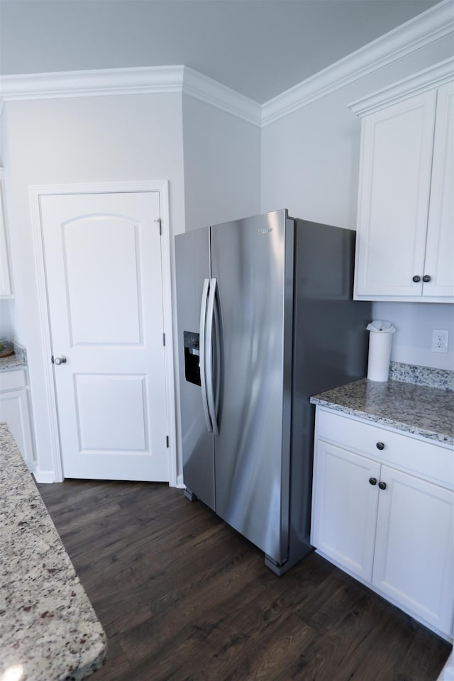 kitchen featuring light stone countertops, dark wood-type flooring, white cabinets, stainless steel fridge with ice dispenser, and crown molding