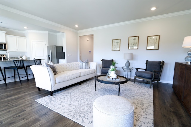 living room featuring crown molding, baseboards, dark wood-type flooring, and recessed lighting