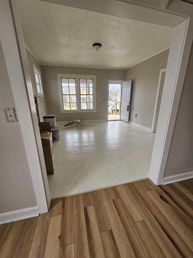 interior space with wood finished floors and baseboards